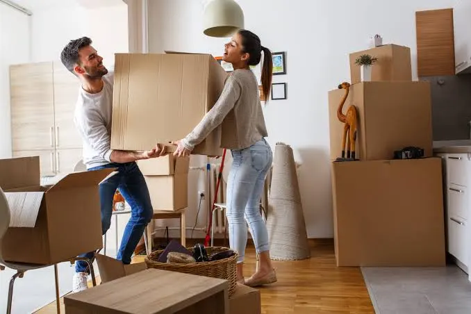 Couple carrying boxes while moving home in Johannesburg