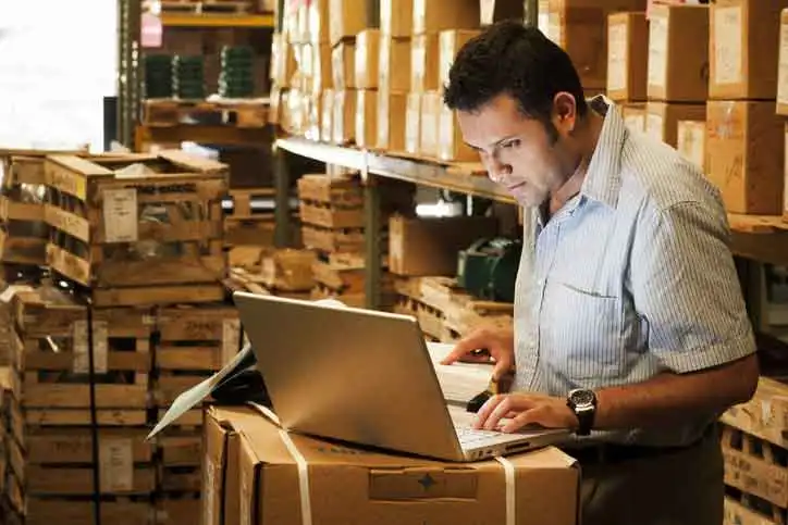 Business owner working among stock boxes in a storage unit