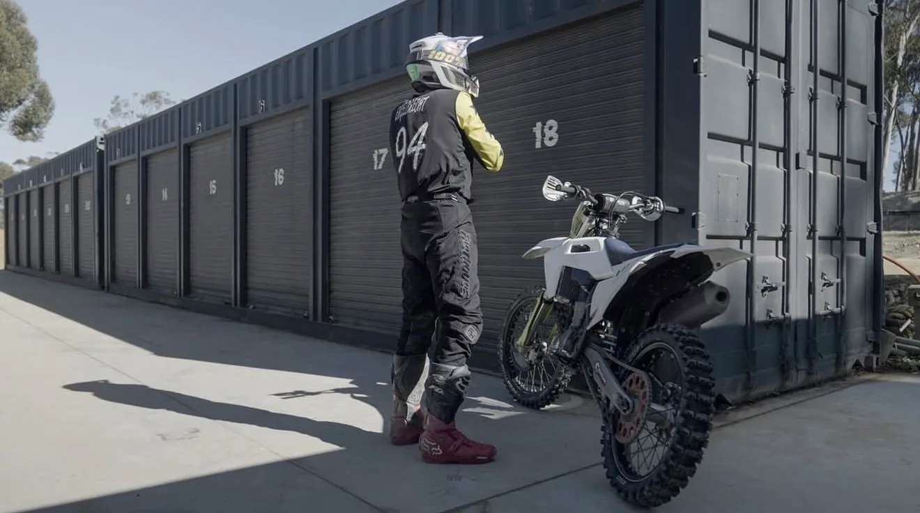 Motocross rider beside his bike at a Cape Storit storage unit