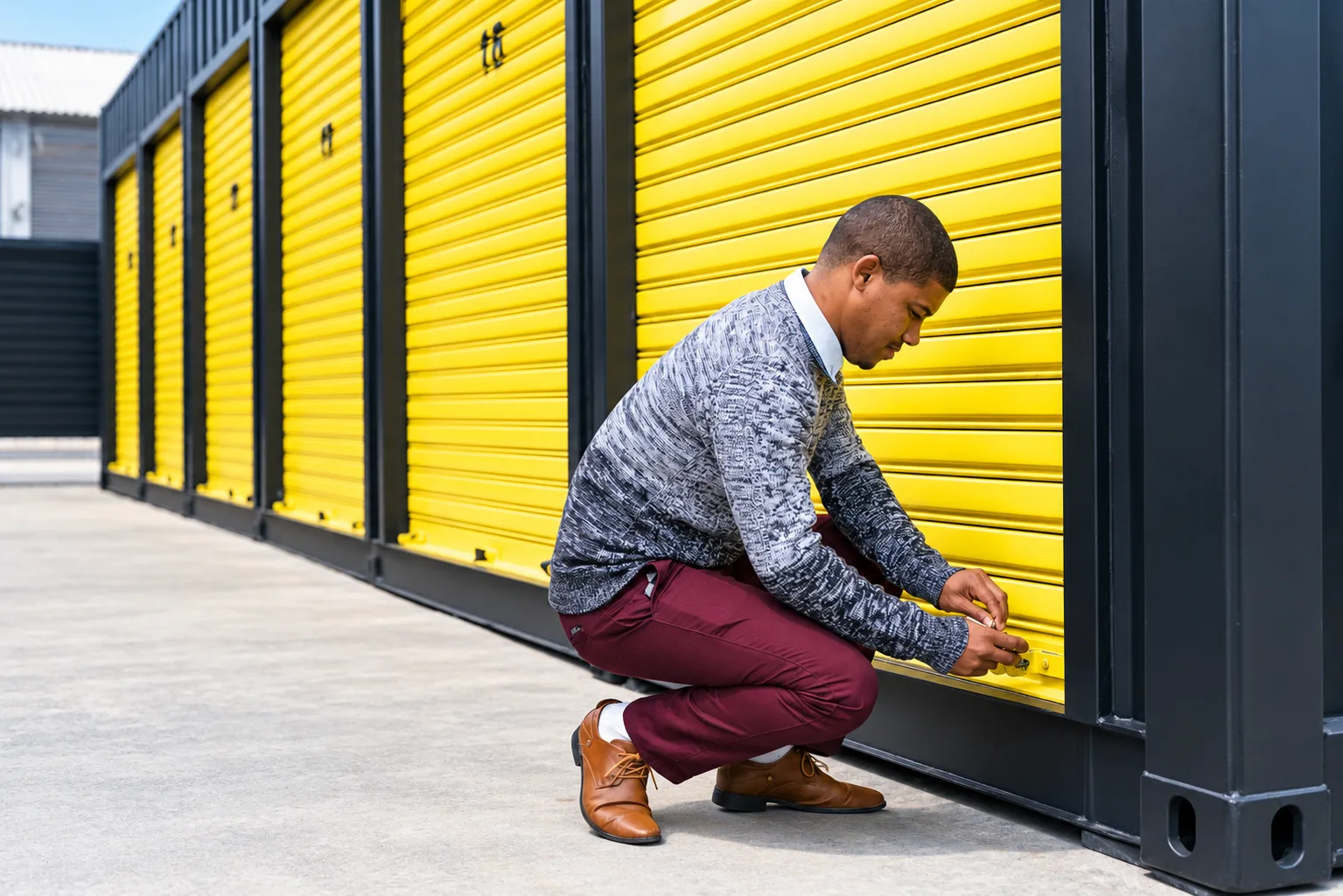 A customer unlocking their own drive-up storage unit at a Cape Storit site