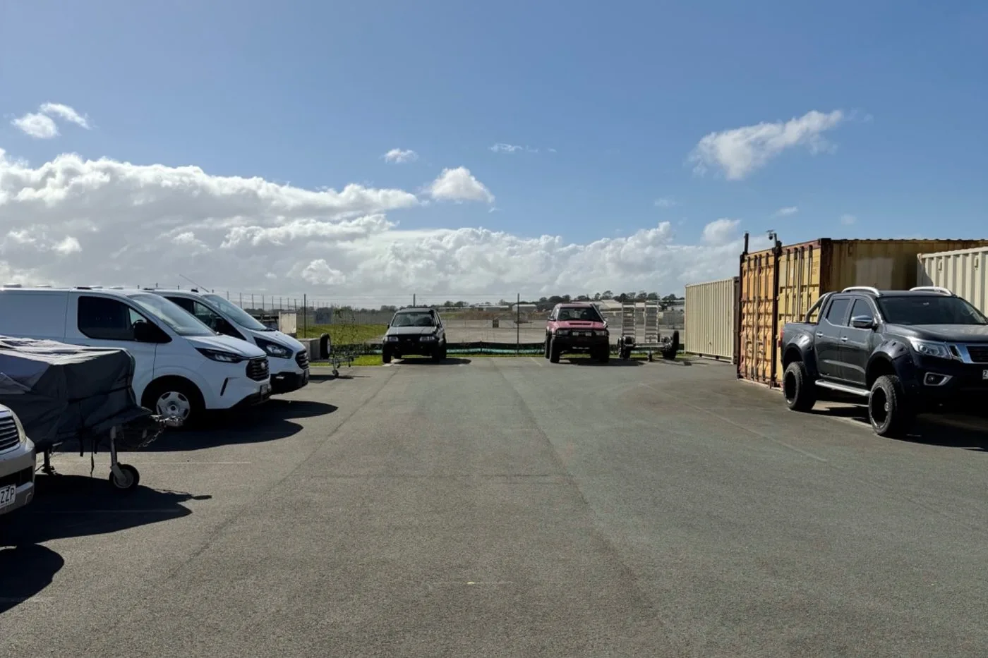 Vans, utes and trailers parked in the secure open-air storage yard at Storage Land, Archerfield Brisbane