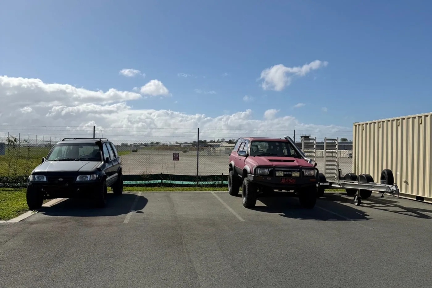 Vehicles parked in open-air storage bays on the sealed bitumen yard at Storage Land, Archerfield Brisbane